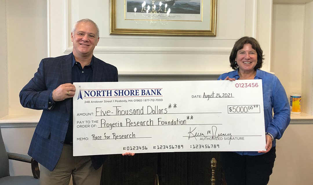Photo of North Shore Bank presenting Progeria Research Foundation with a check for sponsorship of Progeria Race for Research