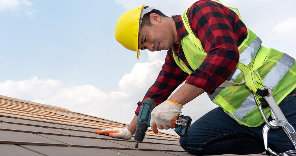 Repairman fixing roof - Condominium Association Loans