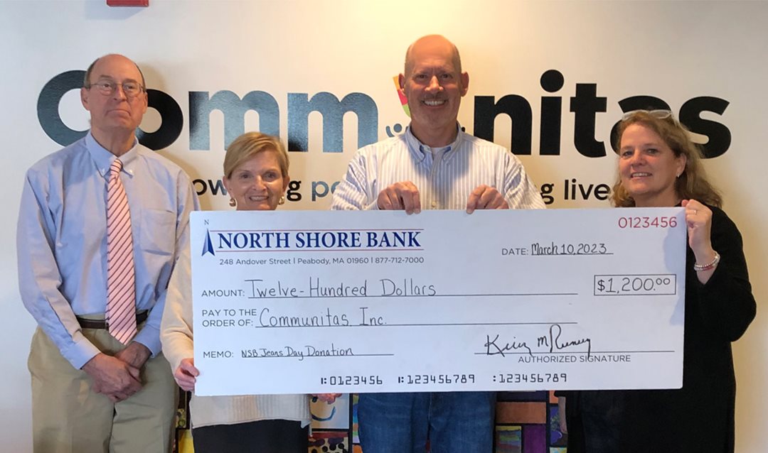 Photo of North Shore Bank presenting Communitas with a $1,200 Jeans Day check.