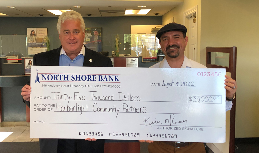 Kevin Tierney, CEO of NSB presenting Andrew DeFranza of Harborlight Community Partners a check to support affordable housing