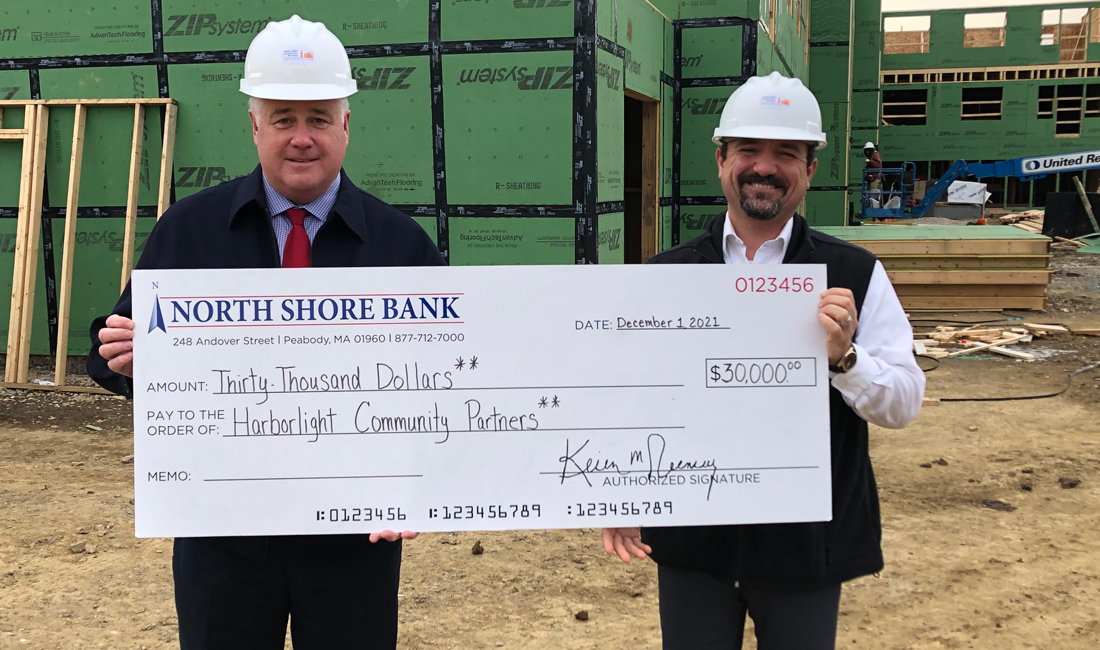 Photo of North Shore Bank presenting Harborlight Community Partners with a donation