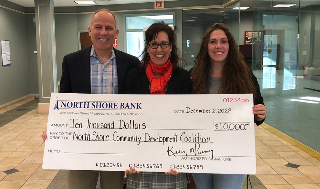 Photo of North Shore Bank presenting a donation to the North Shore CDC to support their mission of affordable housing