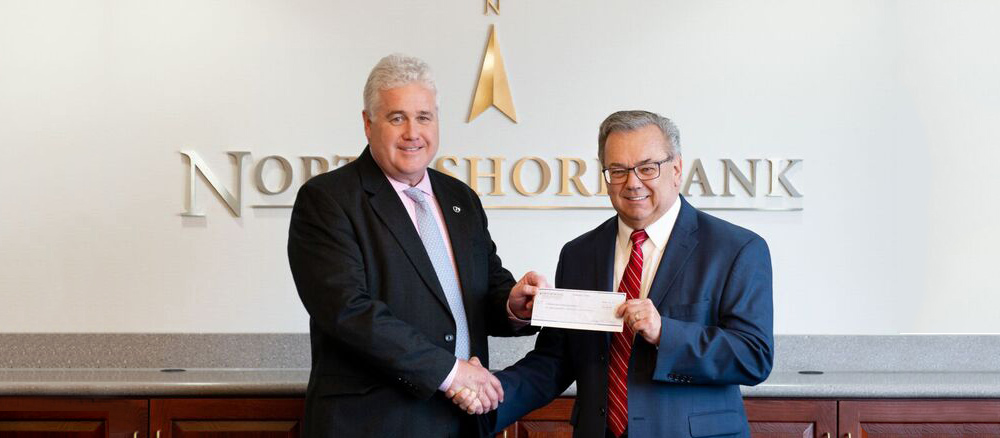 North Shore Bank President, Kevin Tierney, presenting $1,000  to David Gravel of the Peabody Education Foundation