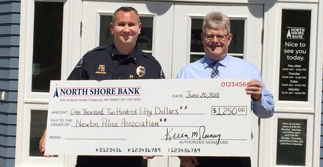 North Shore Bank Manager presenting $1,250 to Newton, New Hampshire Police Department for office renovations