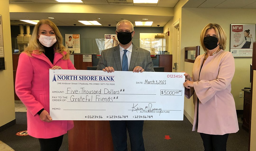 Photo of North Shore Bank presenting Grateful Friends with a donation to help cancer patients facing financial difficulties.