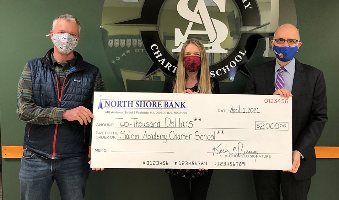 Photo of North Shore Bank presenting the Salem Academy Charter School with a $2,000 contribution