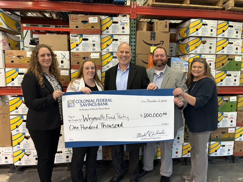 A check presentation for a donation to Weymouth Food Pantry through our charitable giving program, The Giving Tree.