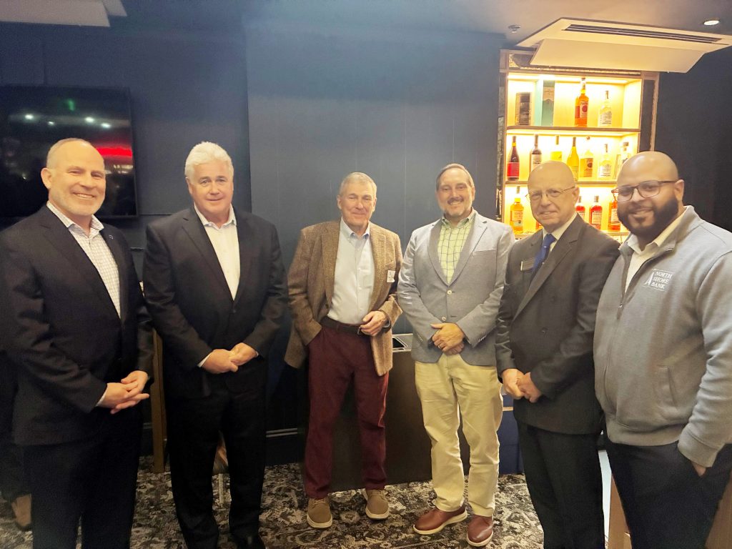 A group of men attending the ribbon cutting ceremony at the Cabot Performing Arts Center to Sponsor New Stageside Lounge.